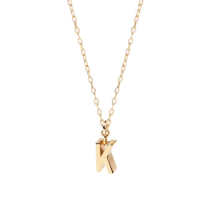 Minimalist gold letter K pendant necklace with a delicate anchor chain and secure clasp, perfect for layering or wearing solo.
