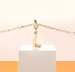 Load image into Gallery viewer, Petite Glow Initial Necklace with the letter L pendant, crafted in 18K gold plating and set on a fine anchor chain for effortless style.
