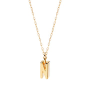 Personalized dainty “N” charm necklace in warm gold tones, adding a soft glow to your neckline.

