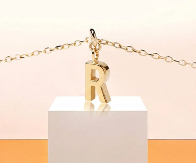 Minimalist letter R necklace featuring a small gold initial charm perfect for layering