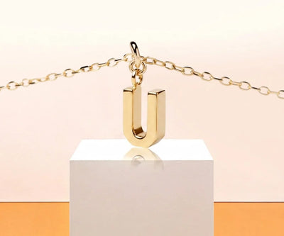 Dainty letter U necklace in gold with minimalist initial pendant on a delicate chain