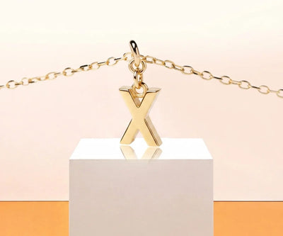 Elegant X initial necklace featuring a small gold letter pendant for everyday wear