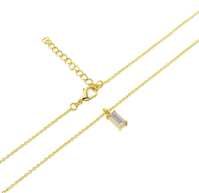 April birthstone necklace baguette cut diamond zircon pendant 14k gold. A dainty clear quartz pendant necklace designed for women born in April, styled with the brilliance of a delicate zircon necklace for added sparkle and elegance.  
