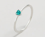 Minimalist heart ring featuring a pale green aquamarine, crafted in 925 silver for delicate everyday wear.
