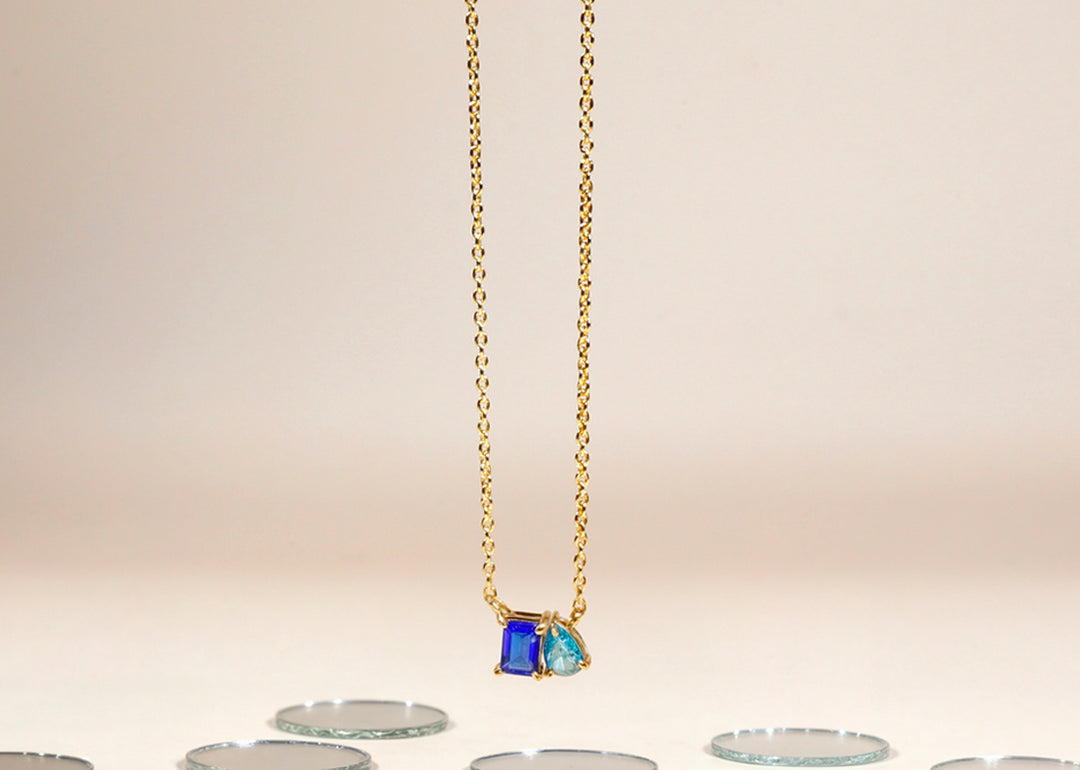 Model wearing two-stone sapphire and topaz necklace