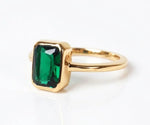 Elegant lab emerald ring with vibrant green gemstone in a classic setting
