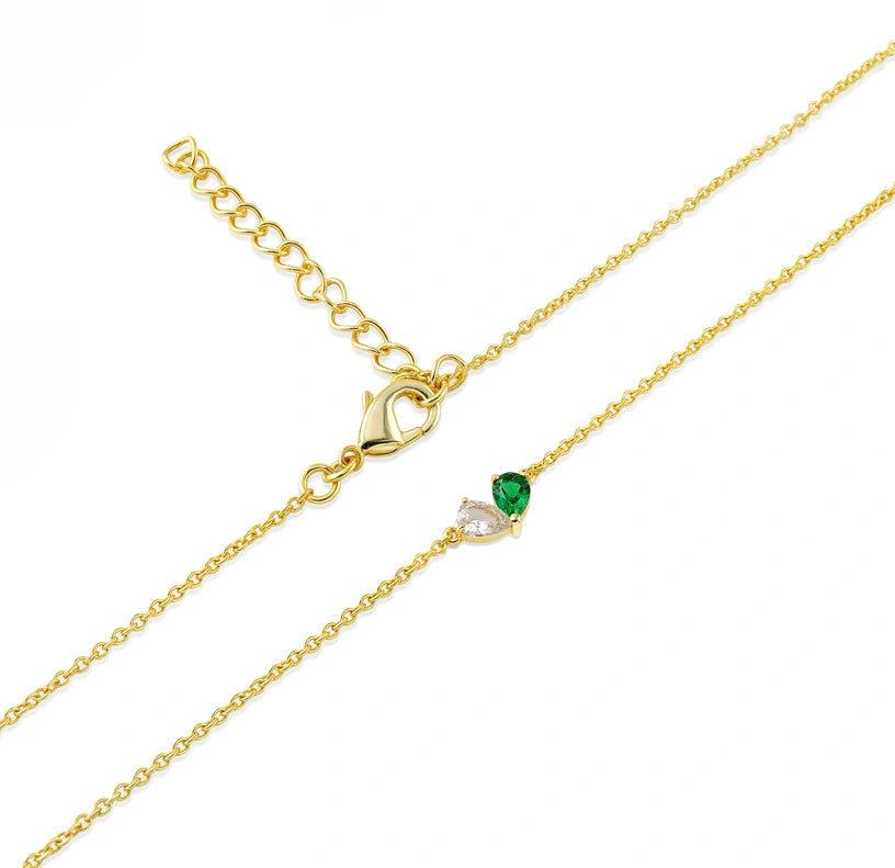 Pear-cut emerald and zircon necklace designed in a symbolic heart duet, suspended on a sleek, adjustable yellow gold chain. Toi Et Moi Pendant Necklace  