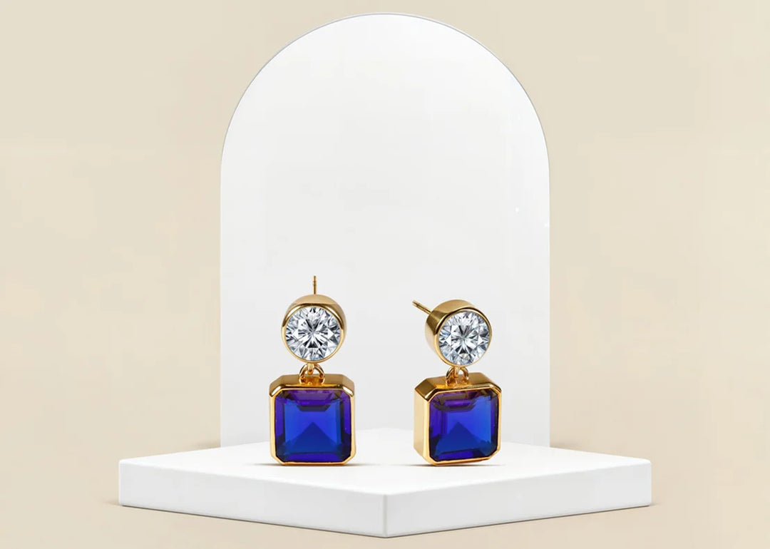 Gold-plated dangle earrings with blue sapphire and cubic zirconia accents

