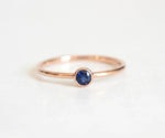 Elegant blue sapphire engagement ring with sparkling diamond halo in white gold setting
