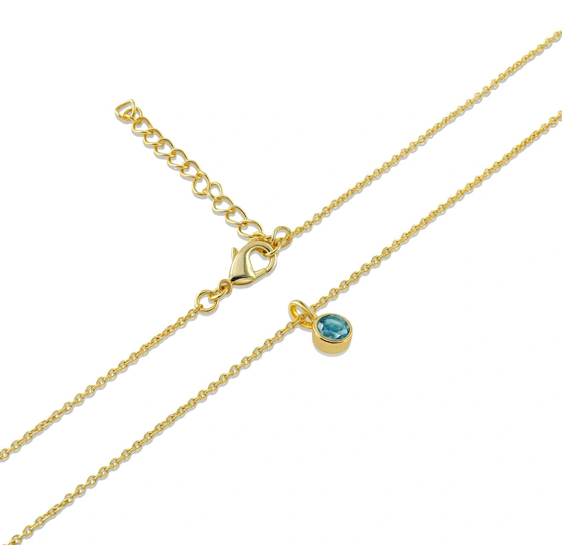 A stunning December birthstone necklace crafted with a shimmering blue topaz for timeless elegance.

