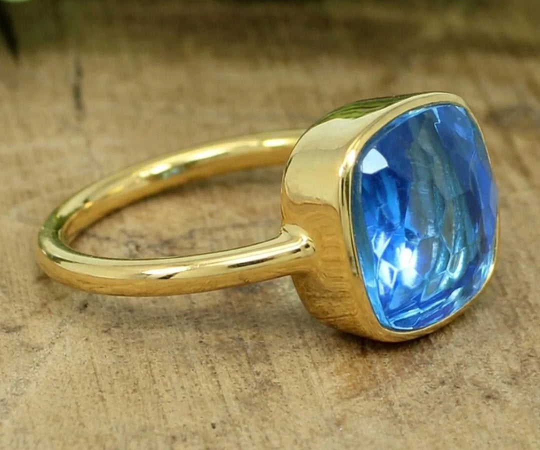 Blue topaz stackable ring with delicate band and sparkling sky blue gemstone for everyday wear