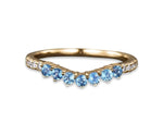 Elegant blue topaz wedding ring with sparkling gemstone and classic band design
