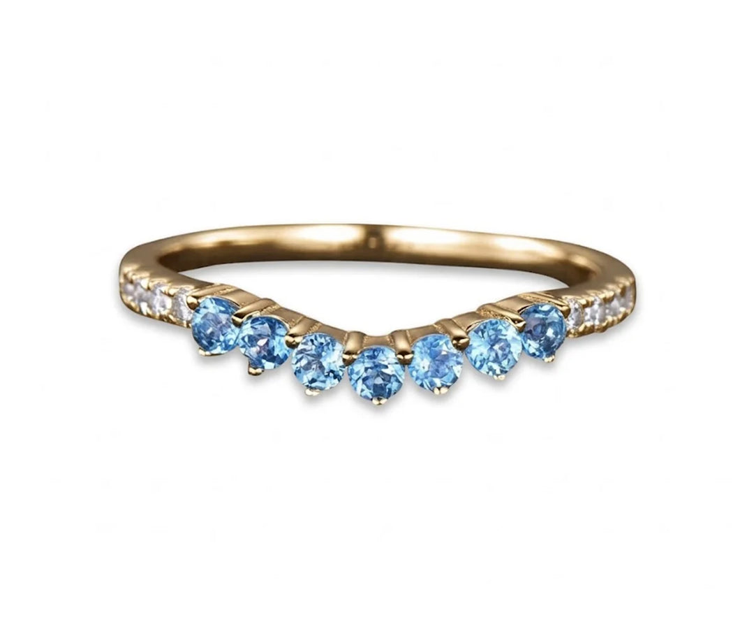 Elegant blue topaz wedding ring with sparkling gemstone and classic band design