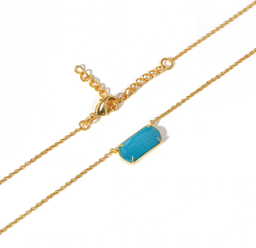 Turquoise aura necklace with a unique silhouette, showcasing vibrant color and graceful movement ideal for gifting or personal keepsake.