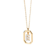 An initial gold pendant featuring a polished letter charm on a delicate gold chain, offering a personalized and elegant jewelry piece.