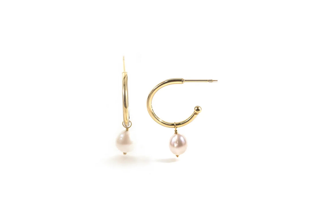 Close-up of modern pearl hoops with push back closure