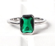 Elegant solid silver ring with a radiant emerald hydro stone, blending timeless charm and modern sophistication
