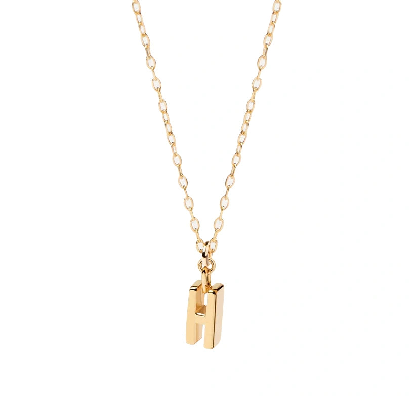 Elegant 18K gold-plated necklace with a dainty letter "H" pendant, radiating personal charm and style. Dainty Initial Necklace - H