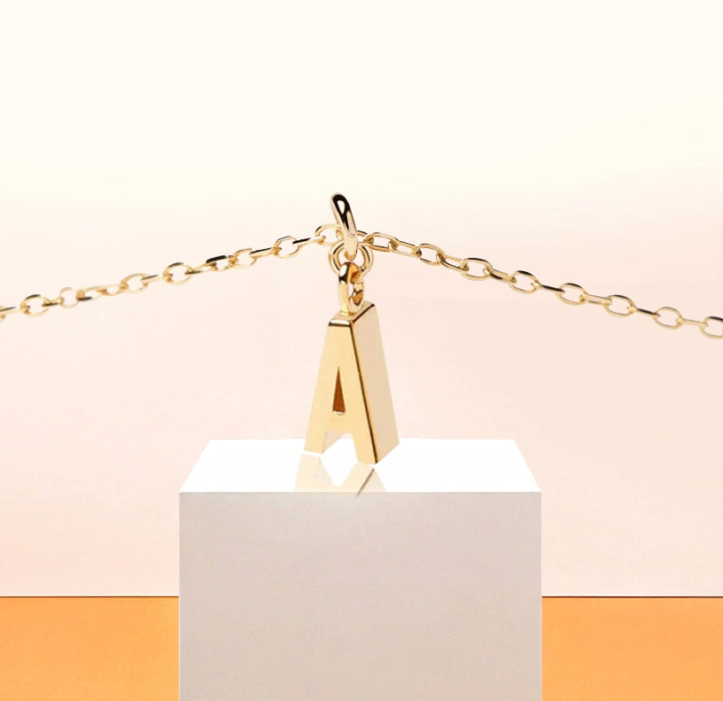 Minimalist necklace featuring an elegant gold-plated A charm on a short adjustable chain, styled for effortless sophistication and daily wear.