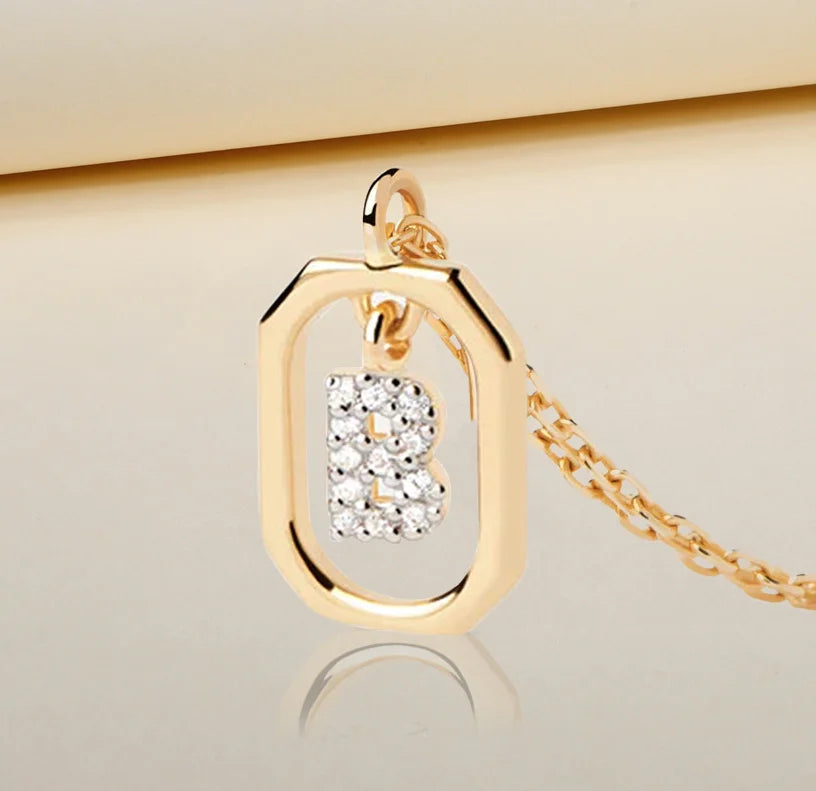 A B initial necklace gold featuring a polished letter “B” pendant on a delicate gold chain, offering a personalized and elegant jewelry piece.