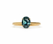 Teal sapphire engagement ring with ocean-inspired hues and timeless elegance