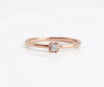 Halo zircon ring featuring center stone surrounded by small shimmering accents
