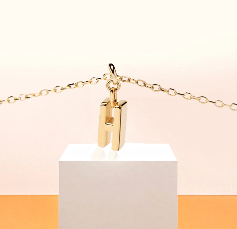 Petite and polished letter "H" pendant on a sleek chain, letter h necklace gold crafted for effortless everyday elegance.