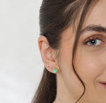 Elegant chrysoprase stud earrings featuring vibrant green gemstones in a classic gold setting.


