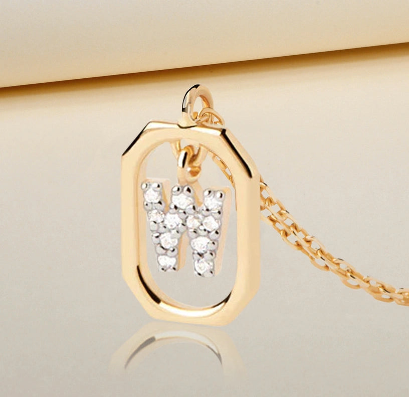 Elegant W initial necklace featuring a shimmering white zircon pendant that catches the light on a delicate gold anchor chain with adjustable length