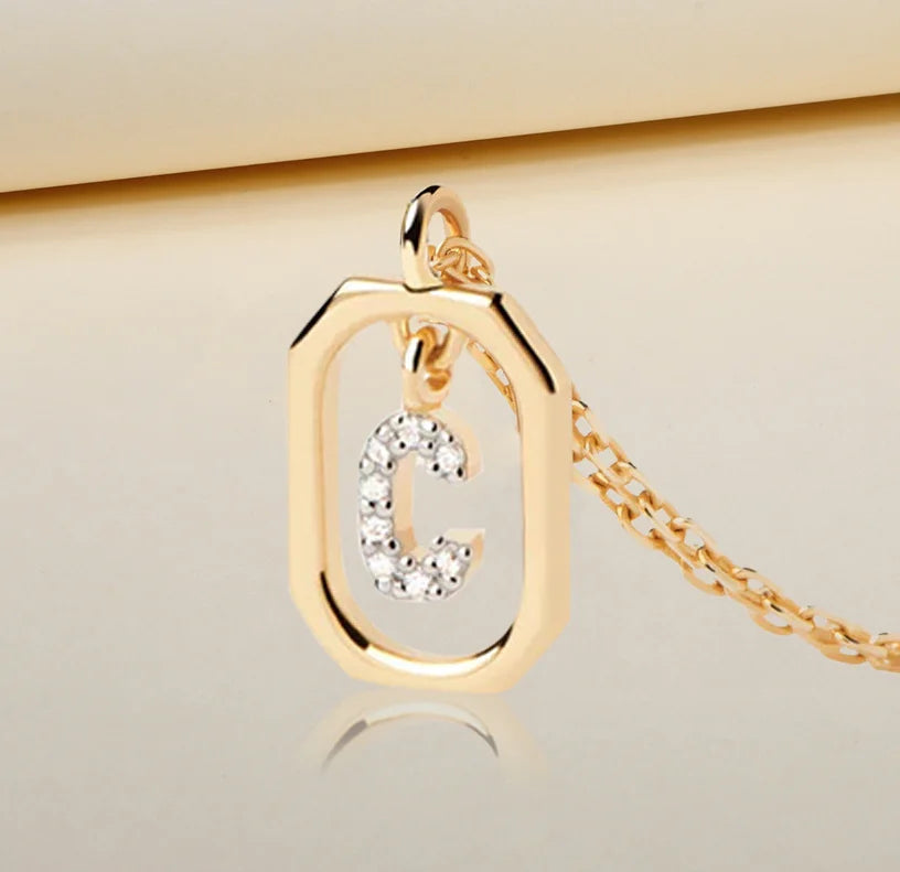 A gold initial C necklace featuring a polished letter “C” pendant on a delicate gold chain, adding a personalized and elegant touch to any outfit, making it a stylish necklace with C on it.
