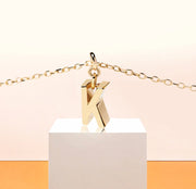 Elegant initial K necklace in 18K gold-plated brass with a 9mm x 3mm pendant, designed for timeless, personalized style.