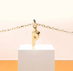 Delicate initial "P" charm necklace, adding a refined golden shimmer to any outfit.
