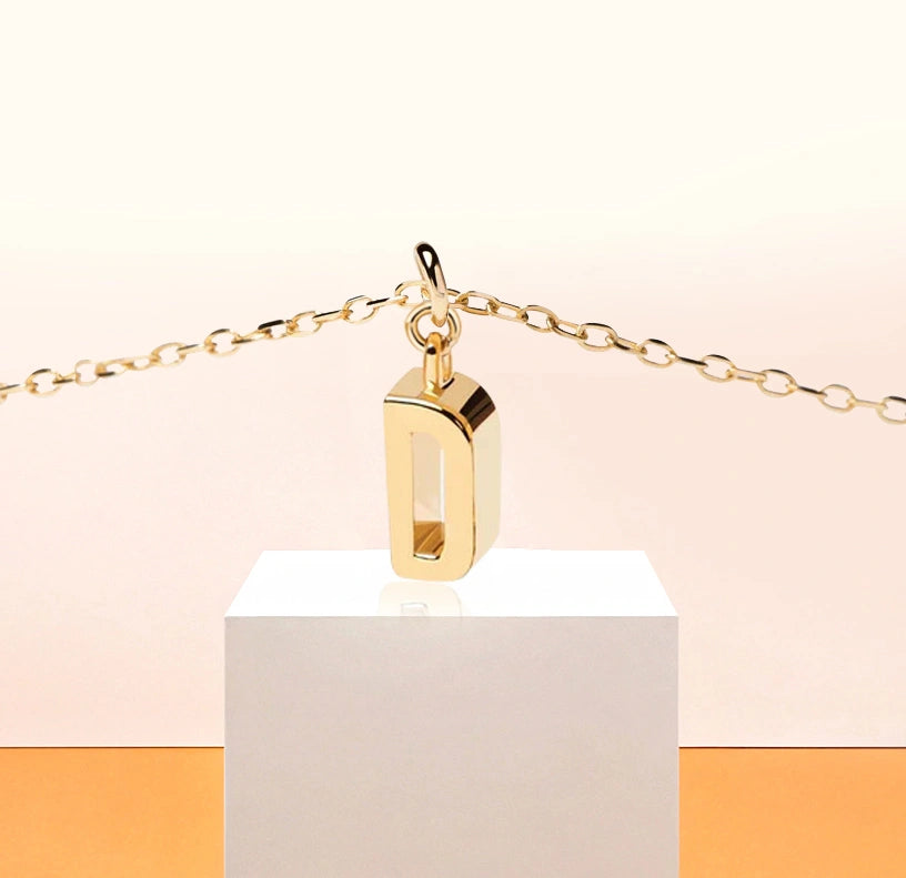 Elegant gold letter "D" pendant on a dainty adjustable chain, radiating personal charm and minimalist beauty.