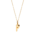 Gold dainty initial "P" necklace glowing with minimal elegance and personal charm.
