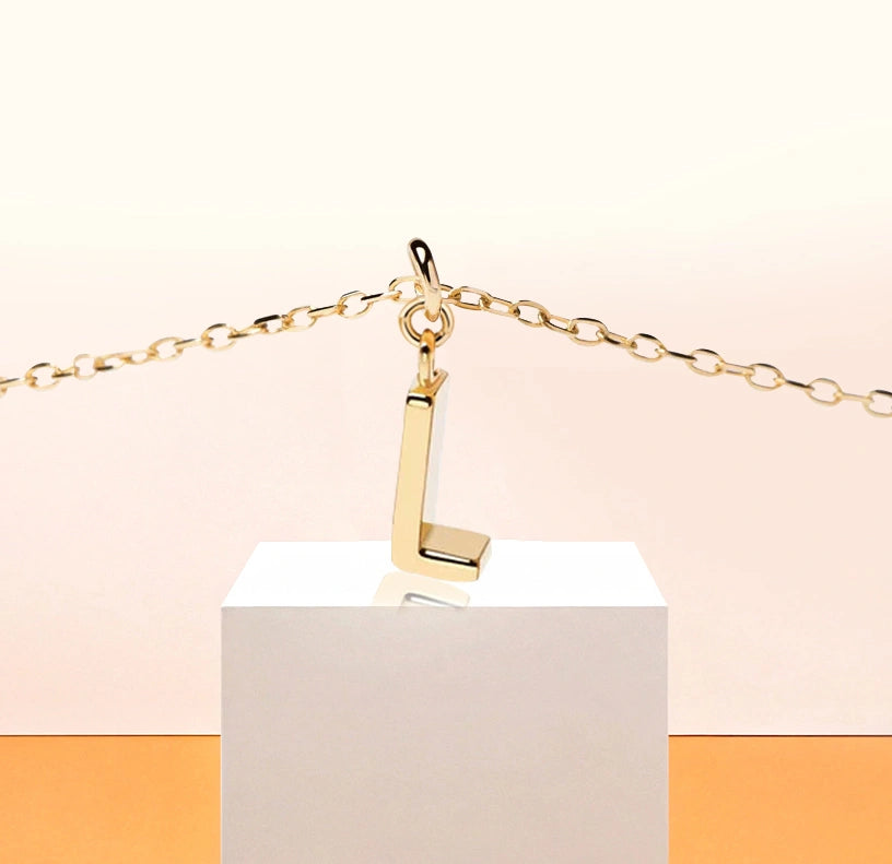 Petite Glow Initial Necklace with the letter L pendant, crafted in 18K gold plating and set on a fine anchor chain for effortless style.