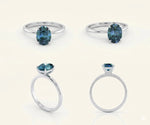 Vintage style teal sapphire engagement ring featuring deep blue green gemstone and halo diamonds

