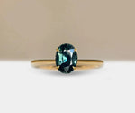 Teal sapphire engagement ring with ocean-inspired hues and timeless elegance

