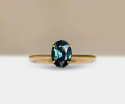 Teal sapphire engagement ring with ocean-inspired hues and timeless elegance