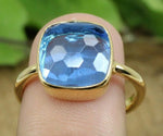 Dainty blue topaz stackable ring with a polished band and subtle gemstone shine for modern styling
