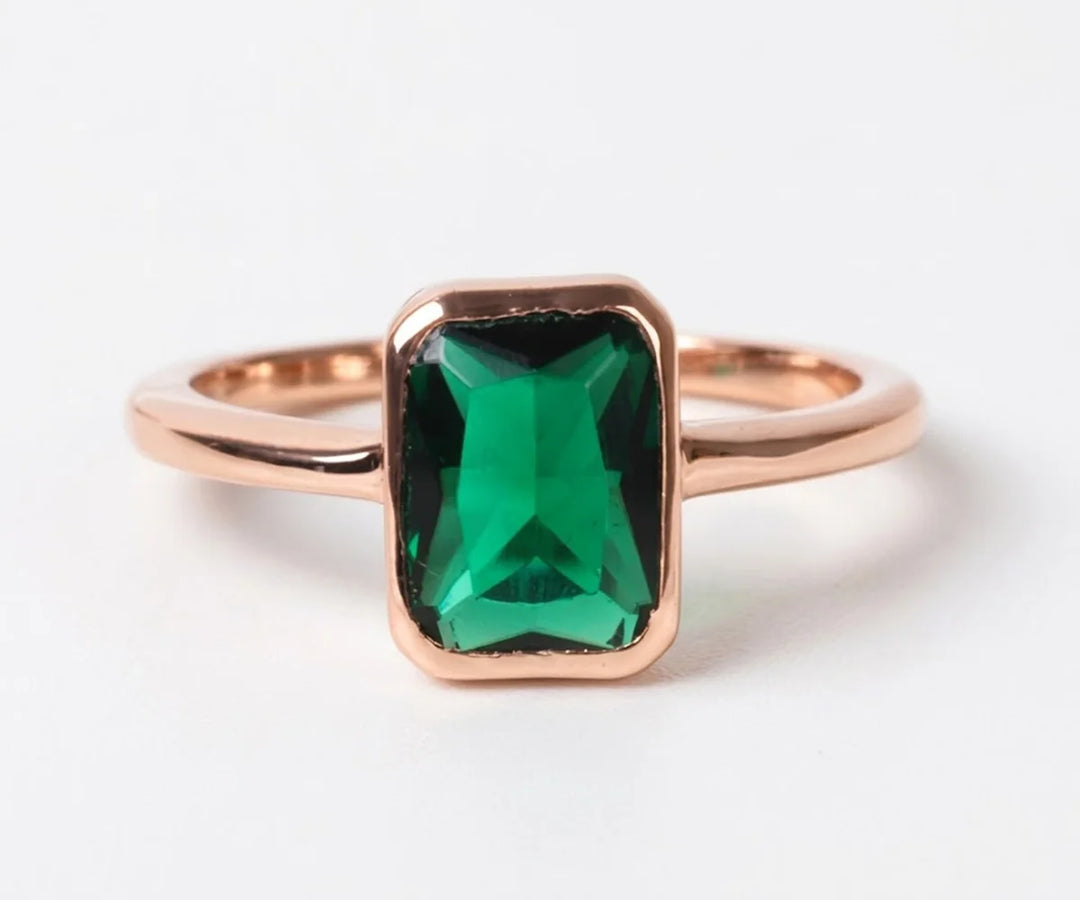 Vintage-inspired lab emerald ring featuring a rich green center stone