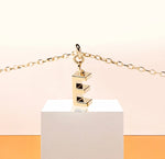Gold dainty initial necklace with letter E pendant on an adjustable anchor chain, finished with a lobster clasp for a personalized and elegant look.
