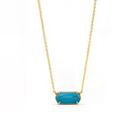 Turquoise pendant necklace featuring a custom-cut gemstone in a gold-plated setting, suspended from an elegant adjustable anchor chain.Turquoise Stone Necklace
