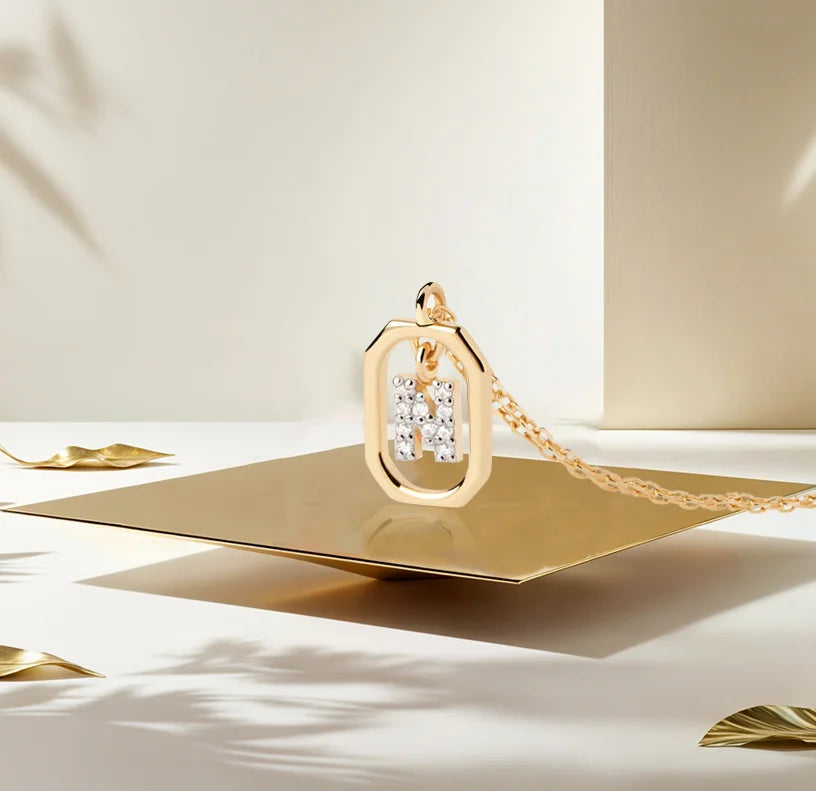 A N necklace gold featuring a polished letter “N” pendant on a delicate gold chain, offering a personalized and elegant jewelry piece.
