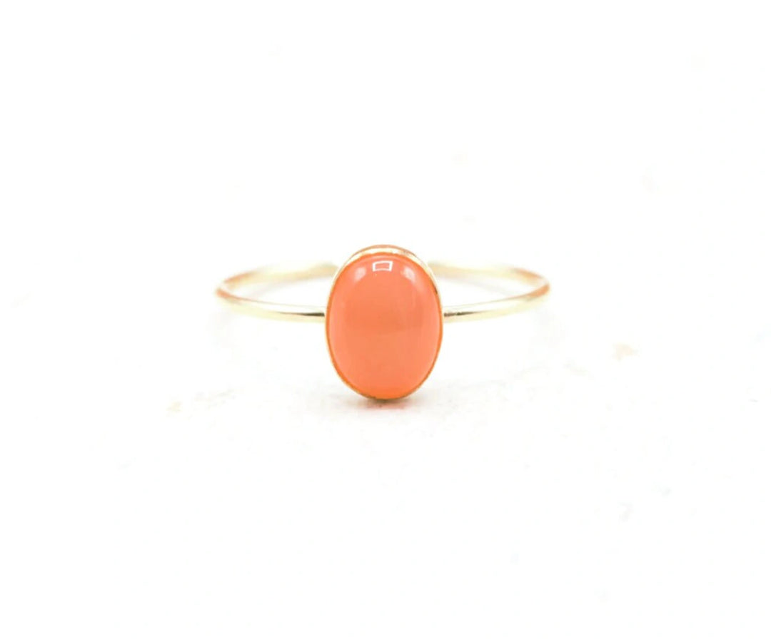 Handcrafted moonstone ring in gold-filled or silver, featuring a glowing 8x6mm gemstone with earthy red-orange tones.


