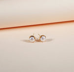 Bold pearl stud earrings with yellow gold plating
