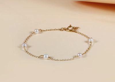 A pearls bracelet featuring a string of lustrous, round pearls, creating a classic and elegant jewelry piece for everyday or special occasions.