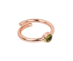 Elegant peridot ring with vibrant green gemstone set in a polished gold band
