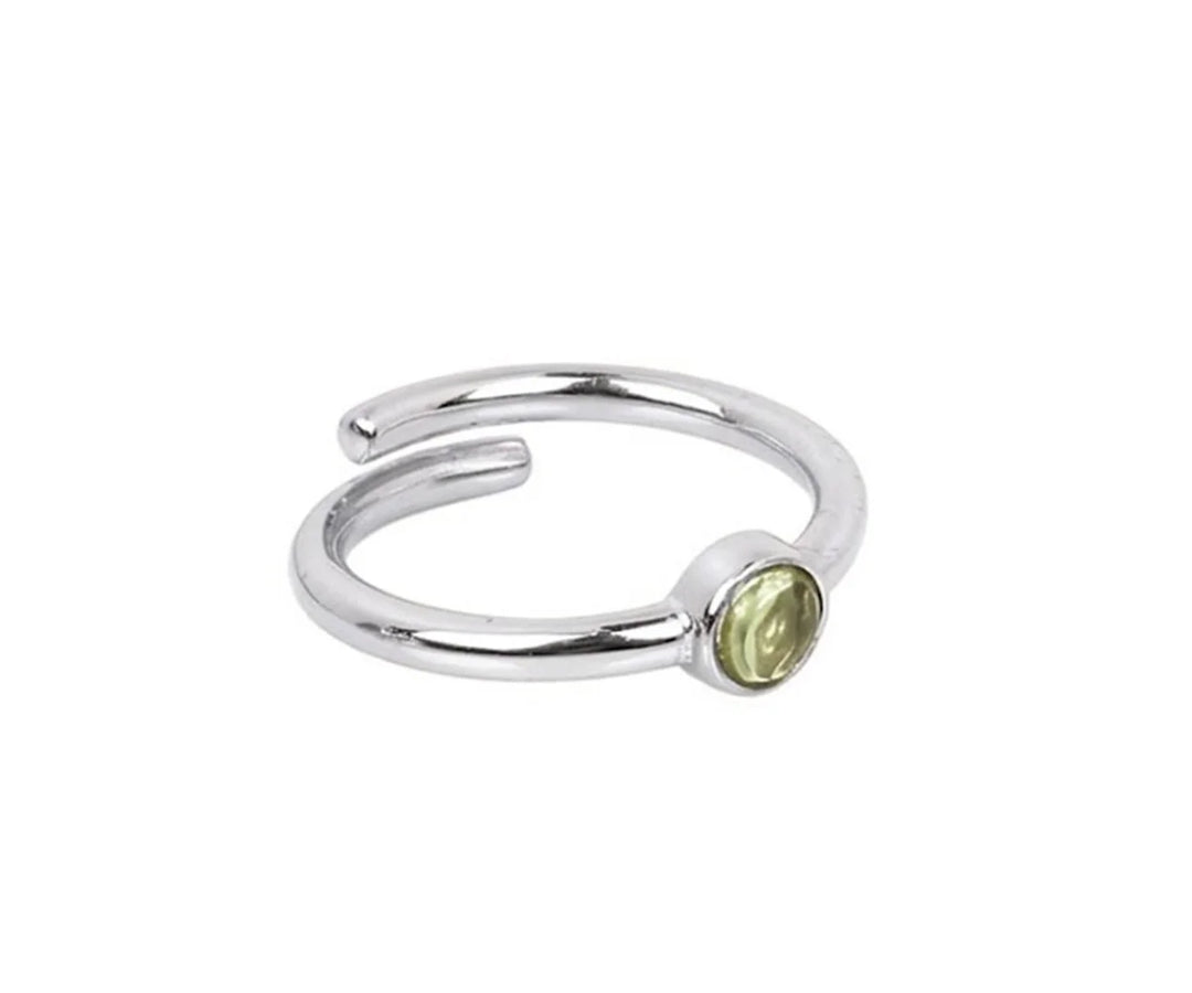 Dainty peridot gemstone ring featuring a fresh green August birthstone design