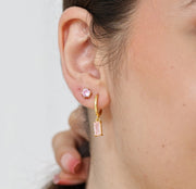 Rose quartz colorstone earrings suspended from gold-plated hoops, combining subtle charm with timeless style.