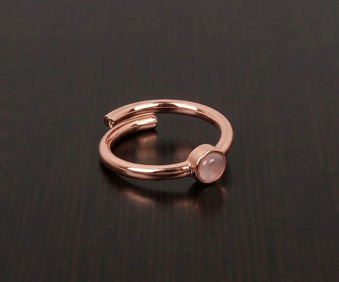 Classic rose quartz statement ring with smooth oval stone in a feminine and romantic style